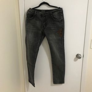 Distressed Jeans with Medusa Decor